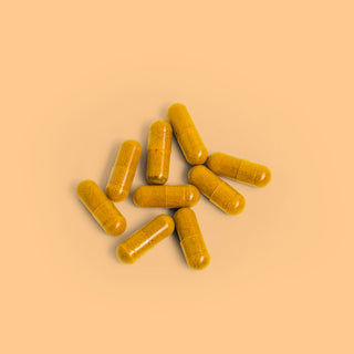 Close-up of Herbaly's Heart Turmeric Complete Plus CoQ10 Capsules showing their size, shape, and color