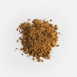 Close-up of the dark brown powder from Herbaly's Mood Mushroom Complete for Stress Capsules showing its fine texture